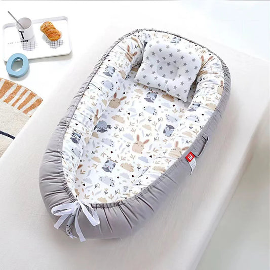 Forest animal-themed baby nest with cozy and breathable cotton fabric.