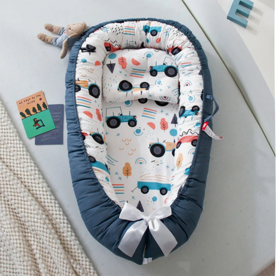 Tractor-themed baby nest with cozy and breathable cotton fabric.