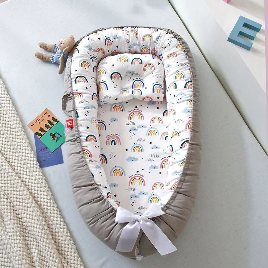 Rainbow-themed baby nest with cozy and breathable cotton fabric.