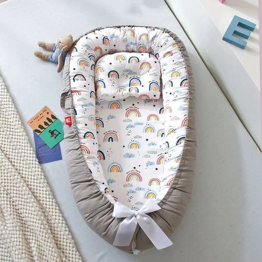 Rainbow-themed baby nest with cozy and breathable cotton fabric.