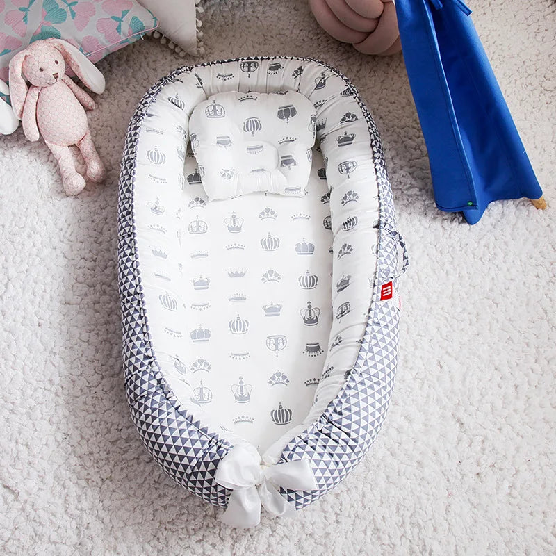 Crown-themed baby nest with cozy and breathable cotton fabric.